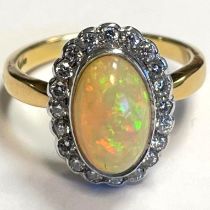 An Ethiopian opal and diamond white and yellow gold 18ct ring. Opal approximately 2.79cts,
