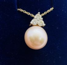 *******AWAY TO VENDOR******* A peach cultured pearl and diamond pendant and chain. Featuring 3 round