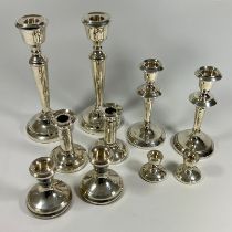 5 pairs of weighted silver candlesticks. Ranging from approx 21cm to 4.5cm.