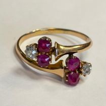 Ruby and diamond 22ct gold ring. Four rubies and two diamonds set in a wrap around ring design. Ring
