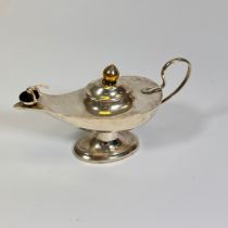 A sterling silver table lighter in the form of an Aladdin style oil lamp Hallmarked for Birmingham