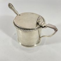 A silver mustard with blue glass liner London 1925/26 D & J W with associated spoon, silver weight