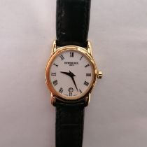 A ladies Raymond Weil 5371 18ct gold plated wristwatch with a date aperture and on a black leather
