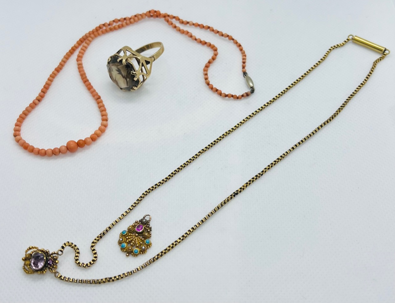 A collection of gem set jewellery. Featuring a yellow metal necklace, featuring bead and wire work