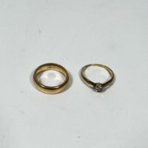 A 9ct yellow gold diamond solitaire ring and a 9ct yellow gold band ring sizes I and J, total weight