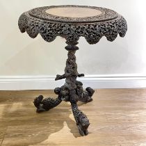 A well carved Colonial tilt top tripod sidetable with an intricate soliate frieze on a carved column