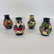 Four Moorcroft squat vases. Approximately 14cm tall. All in good condition. Contains two seconds