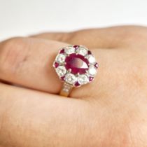 An 18ct hallmarked yellow gold diamond and filled ruby ring. Main ruby approximately 1.35cts, 8