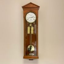A Kieninger 3 train walnet Vienna style wall clock, approx 103cm tall with weights and pendulum.