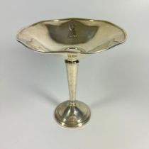 A weighted silver dish on stand, approx 17cm tall and 16cm wide.