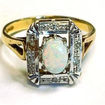 Oval opal 9ct gold ring in rectangular Art Deco setting with small diamonds. Head approximately 12 x