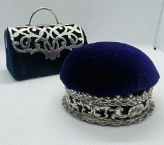 Two sterling silver pin cushions. One formed in  the shape of a handbag or doctors case with