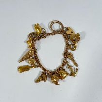 21g - 375 gold charm bracelet with 14 charms, including teapot, shell, heart, thimble, violin,