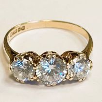 A hallmarked 9ct gold three cubic zirconia ring. Size N. Approximately 2.5 grams