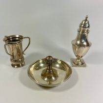 A silver caster approx 17cm tall, a three handled cup and a silver taper candle holder. Total