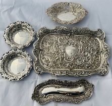 A collection of largely late Victorian sterling silver embossed and pierced-work trays. Featuring an