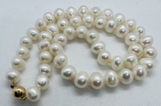 *******AWAY TO VENDOR****** A matinee strand of white cultured pearls. Featuring 49 off round