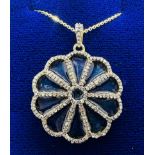 ****AWAY TO VENDOR***** A gilded enamel and diamond flower pendant, set with 1.25 carats (estimated)