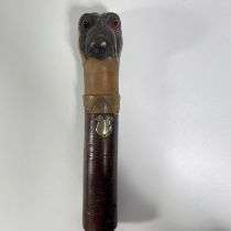 A carved wooden bulldog head pen/brush holder with glass eyes. Approximately 22cm tall.