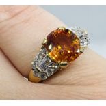 *****AWAY TO VENDOR***** An orange sapphire and diamond set dress ring. Featuring an intense