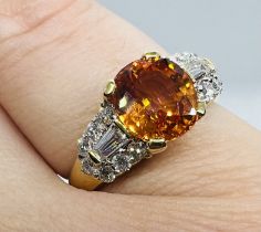 *****AWAY TO VENDOR***** An orange sapphire and diamond set dress ring. Featuring an intense