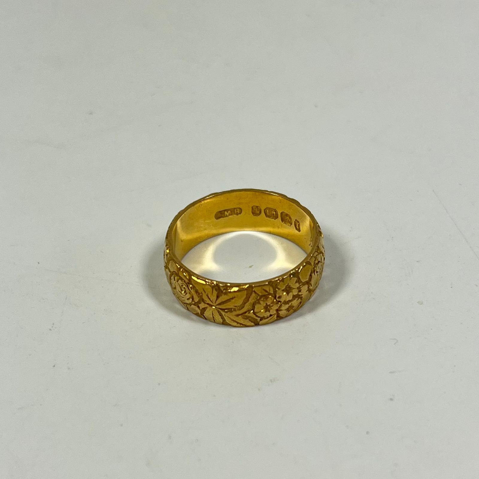 A Hallmarked 18ct yellow gold foliate engraved band ring, size T approx 9grams band width approx