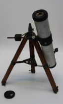 A circa 1990's astrological telescope with tripod stand