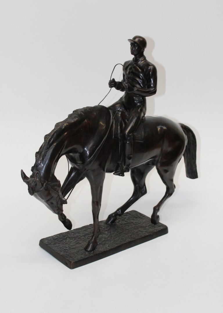 A modern 19th century style cast bronzed figure of a jockey on a horse, height 57cm