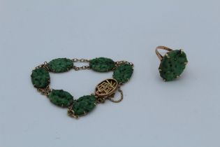 A suite of carved jade jewellery. Comprising a bracelet of six carved oval panels, clasped with a