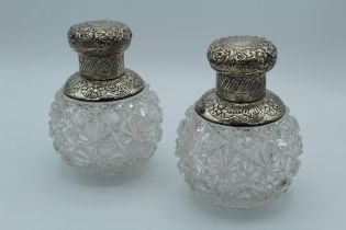 A pair of Victorian silver mounted scent bottles, each with star and hobnail cut glass body,
