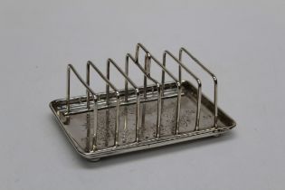 Charles Edward Nixon, a Victorian silver six slice toast rack, with rectangular bright cut leaf