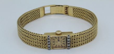 Omega, a mid 20th century lady's 18 carat gold cocktail watch. The square 1cm champagne dial with