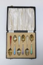 William Suckling Ltd, a cased set of six silver gilt and guilloche enamel coffee spoons.