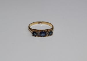 A late Victorian/ Edwardian three stone sapphire and diamond ring. The principal stone approximately