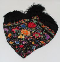 An early 20th century Spanish shawl, brightly woven with bold flowers and trailing foliage, 142 x
