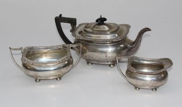 James Deakin and Sons, a George V silver three piece tea service, comprising pot with ebonised