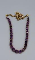 A partial, closed back amethyst riviere necklace, secured on two steel wires, connected to a