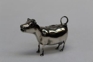 Samuel Boyce Landeck, a 19th century silver cow creamer with hinged cover to back, looped tail and
