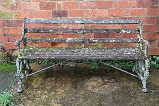 A late 19th century painted cast iron Coalbrookdale framed garden bench, having mask decorated