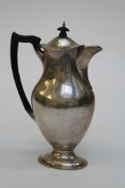 James Deakin and Sons, a George V silver coffee pot of baluster form, with ebonised fittings, raised