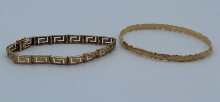 A 14k stamped floral bangle engraved Houvaii 95, weight approximately  17gm with a 9ct gold Greek