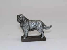 Louis Lejeune, a cast white metal car mascot, modelled as a Newfoundland, standing four-square on