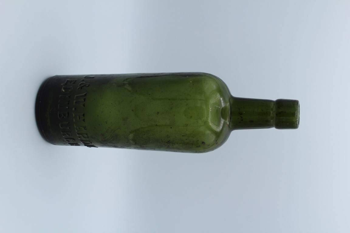 J and W Hardie, Edinburgh. A circa 1900's olive green mallet form Whiskey bottle, 27cm