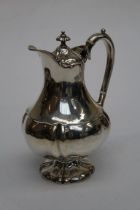 Thomas Russell and Co, an early 20th century silver hot water pot of bellied form, raised on a lobed