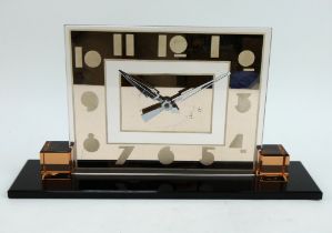 A 1930s Art Deco mirrored glass mantel clock with pink tinted glass dial on a black glass plinth.