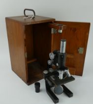 A vintage Bausch & Lomb optical microscope, no 265493, in fitted mahogany case.