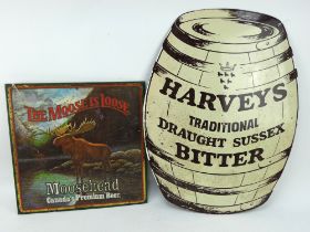 A Harveys Brewery barrel shaped enamel sign and a vintage Canadian Moosehead Beer tin sign.