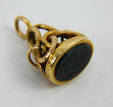 An antique yellow meal fob seal in the form of a serpent with inset monogrammed bloodstone matrix.