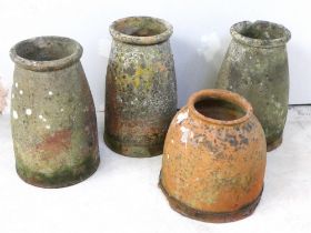 Four antique terracotta rhubarb forcers with well weathered finish. Height: 49cm.