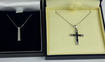 A 9ct white gold and sapphire crucifix and chain, & a similar diamond set pendant and chain.